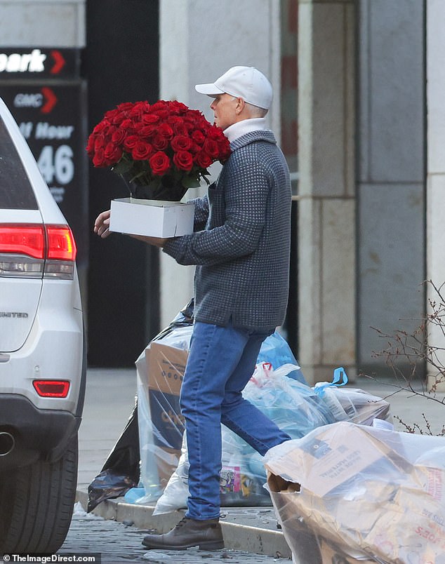 The supermodel was spotted outside her Big Apple office on Wednesday as a courier service delivered a beautiful array of red roses to her door