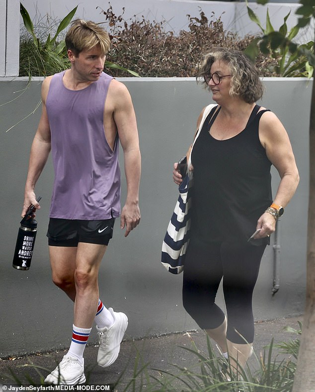 Julie stepped out in all-black activewear, including a black tank top and capri tights