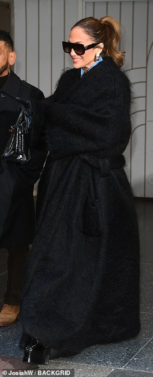 She threw her brunette locks into a sleek ponytail to show off a pair of shiny, silver earrings