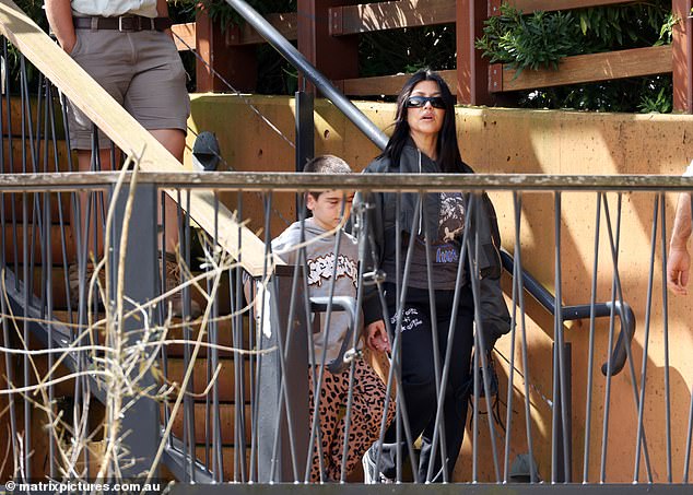 Kim Kardashian's older sister looked casual-cool in a gray cropped bomber jacket with puffed sleeves.  She wore it open to reveal a Motörhead T-shirt