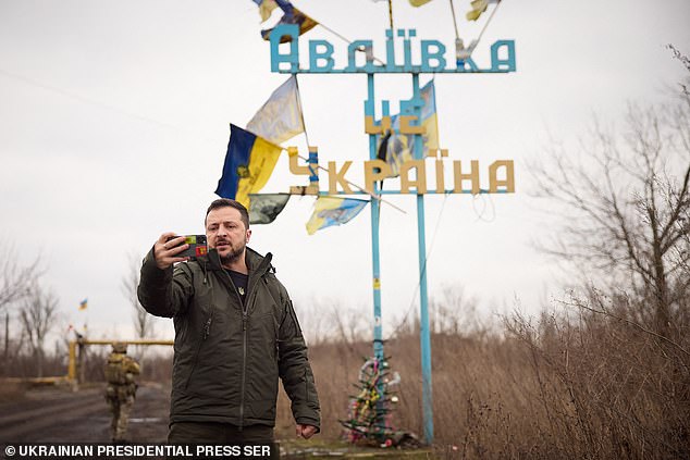 This handout photo, taken and released by the Ukrainian Presidential Press Service on December 29, 2023, shows Ukrainian President Volodymyr Zelensky recording a video speech in front of a sign that reads 