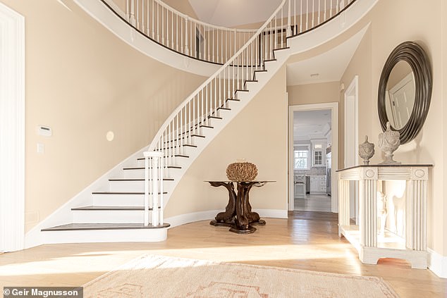 The home is further complemented by a three-car garage, a porte-cochère and a finished basement, which the listing agent says adds to the allure of this Hamptons gem.  In the photo: the large foyer