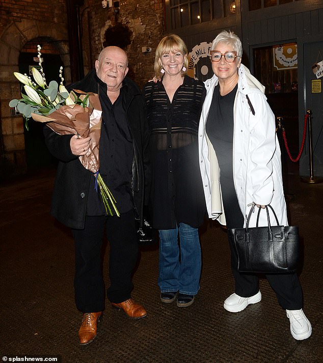 The rocker is the son of actress and Loose Women star Denise, 65, (right) and actor Tim Healy (left), who stepped out for the gig in Manchester with his wife Joan Anderton (centre).