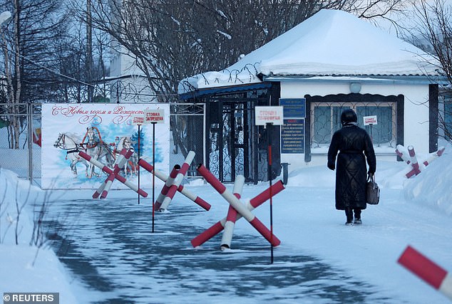 A woman walks to the entrance of the IK-3 penal colony, where Russian opposition politician Alexei Navalny died while serving his prison sentence.  The prison is located in the Kharp settlement in the Yamal-Nenets region