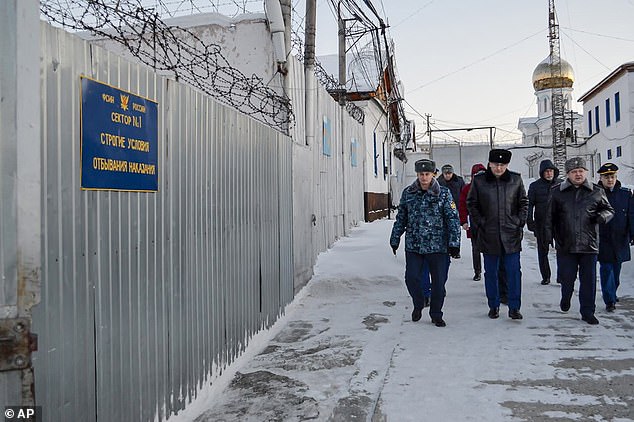 A group of officers walk into a prison colony in the city of Kharp, in the Yamalo-Nenetsk region, about 1,900 kilometers (1,200 miles) northeast of Moscow