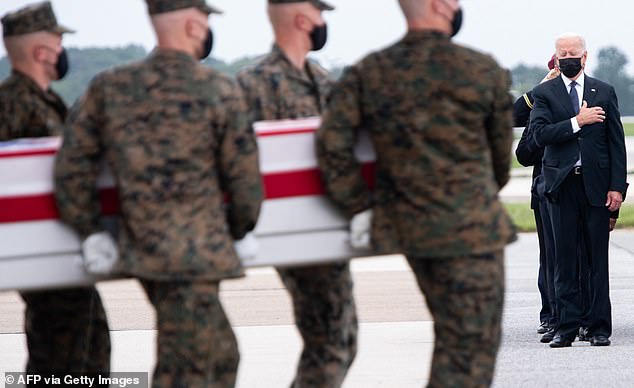 U.S. President Joe Biden(R) attends the dignified transfer of the remains of a fallen service member at Dover Air Force Base in Dover, Delaware, August 29, 2021