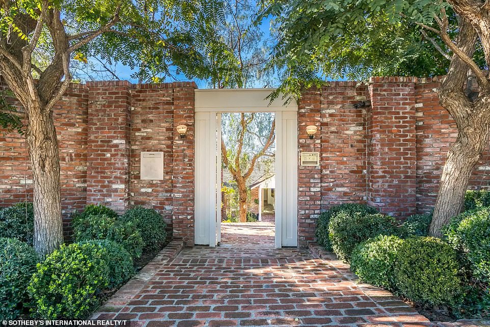 The entrance to Jim's house contained a stone path lined with shady trees and small shrubs