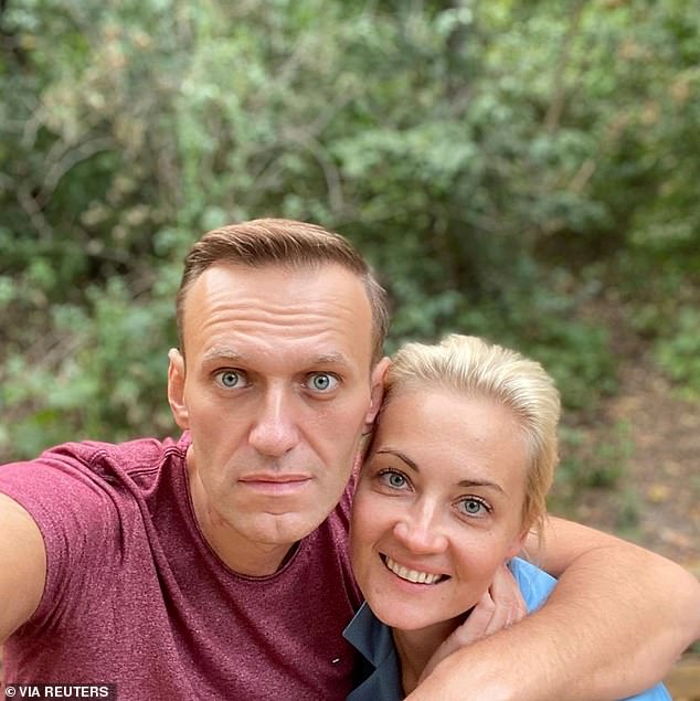 Navalny (pictured with his wife Yulia Navalnaya) miraculously survived a suspected assassination attempt with a nerve agent while on the run in August 2020. He was evacuated to a hospital in Germany and the use of a Novichok nerve agent was later confirmed.