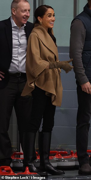 The 42-year-old wore a $1,295 camel-colored cape coat from woman-owned Canadian outerwear brand Sentaler and a pair of $325 MaxMara gloves to cover her wrists and forearms.