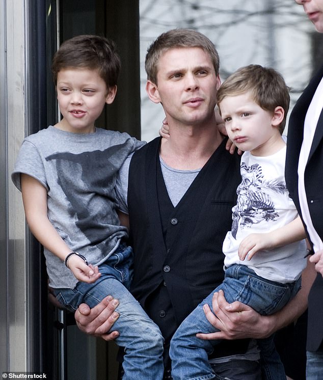 Jeff Brazier carries his sons Bobby and Freddie after Jade's baptism in March 2009