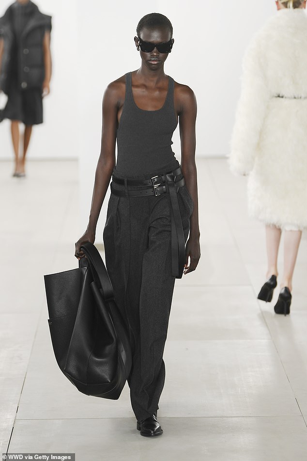 An oversized tote bag is functional and can serve as the focal point of an outfit, as seen at Michael Kors