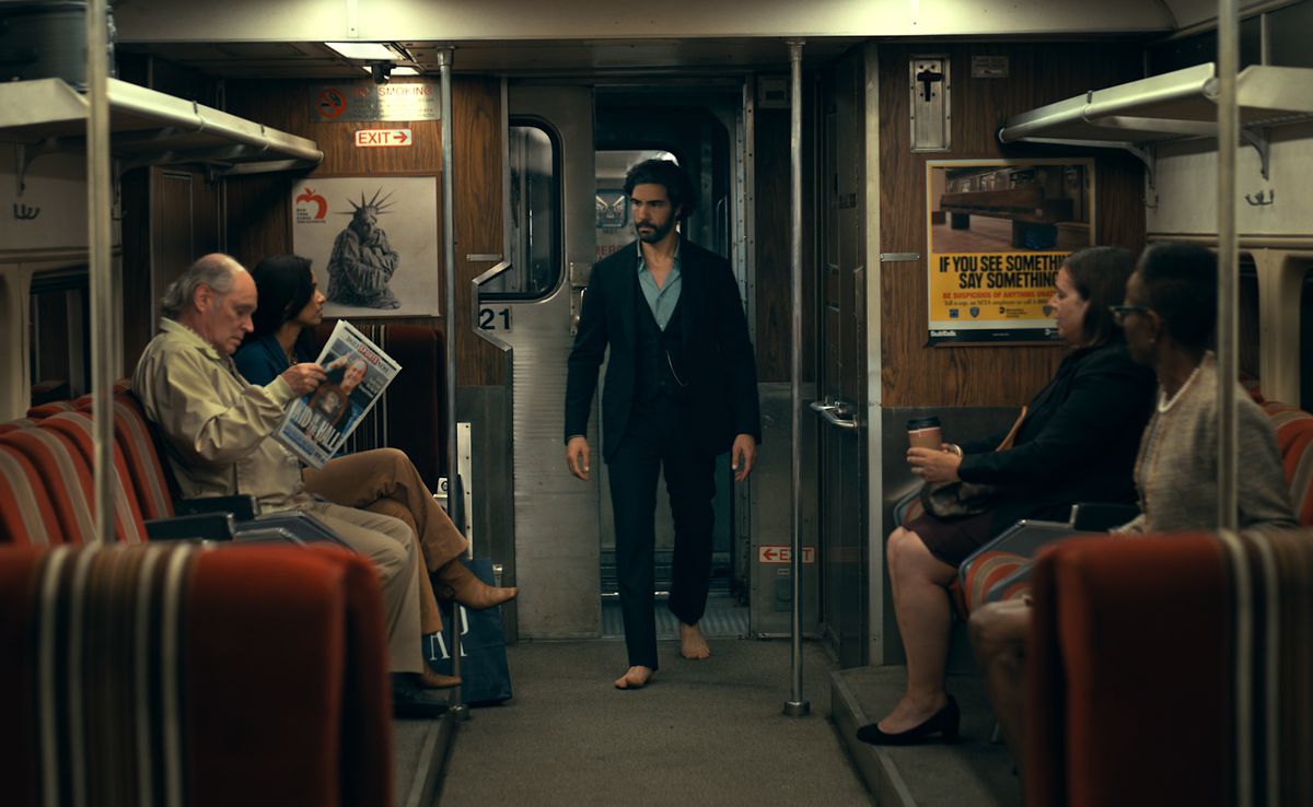 Ezekiel Sims (Tahar Rahim) sneaks around a New York City subway wearing a suit, blue shirt and no shoes (ew, on the SUBWAY?!) in Madame Web