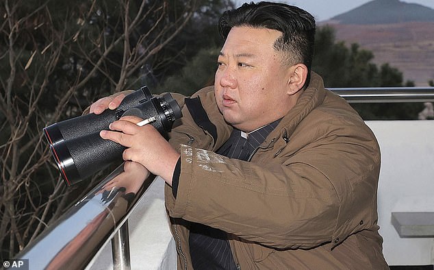 North Korean leader Kim Jong Un looks at what he says is an intercontinental ballistic missile that the country tested at Sunan International Airport in Pyongyang, North Korea