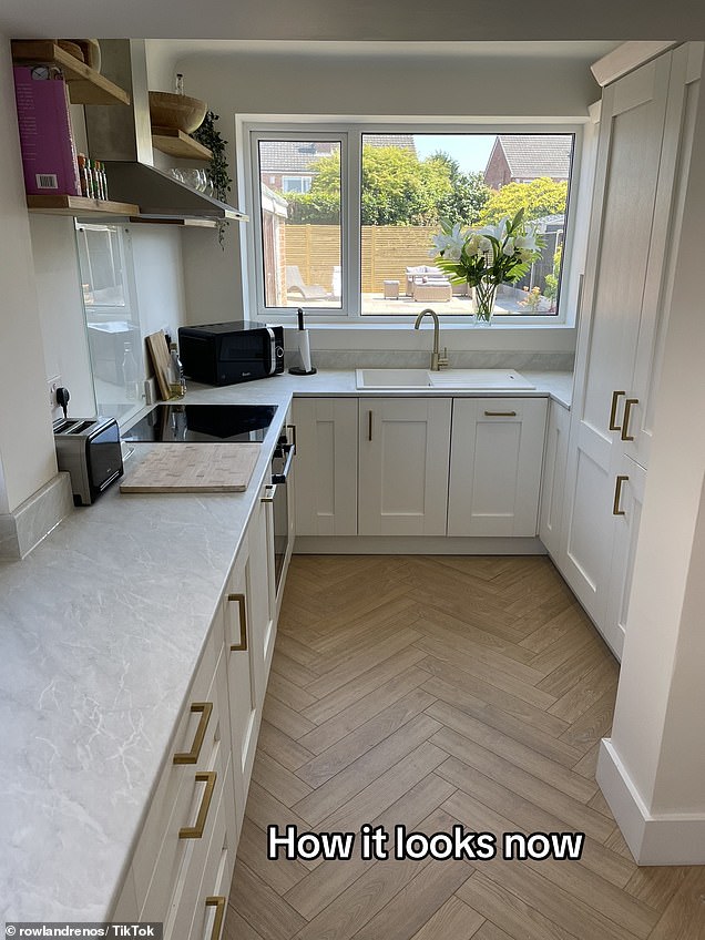 Pine floors and minimalist white units were then fitted and finished with light gray marble worktops and finished with gold hands attached to drawers and cupboards