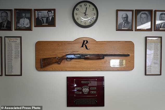 A shotgun made by Remington Arms, donated by the company to the city, hangs on the wall of the municipal building in Ilion, NY