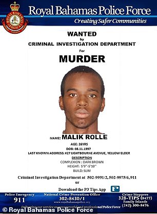 Wanted posters are seen for murder suspects wanted by Bahamian police