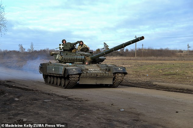 A Ukrainian tank crew drives through roads near the city of Avdiivka on February 17.  As the Ukrainian army withdraws from Avdiivka, reports of heavy losses continue and Russian forces are advancing rapidly.