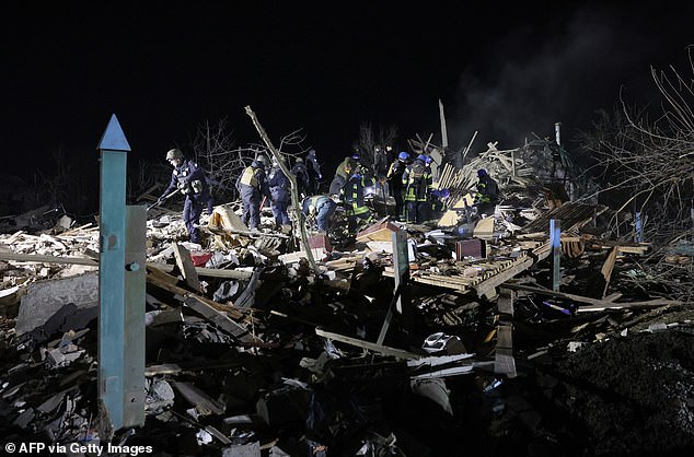 Ukrainian police officers and rescue workers clear the rubble of a destroyed residential house after a Russian missile attack in Kramatorsk, Donetsk region, on February 17