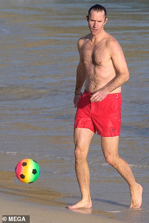 James showed his sporting talent by kicking a ball around on the beach