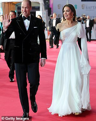 The Prince of Wales grinned as he waved to royal fans waiting for the couple along the red carpet