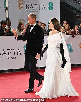 The Prince of Wales grinned as he waved to royal fans waiting for the couple along the red carpet