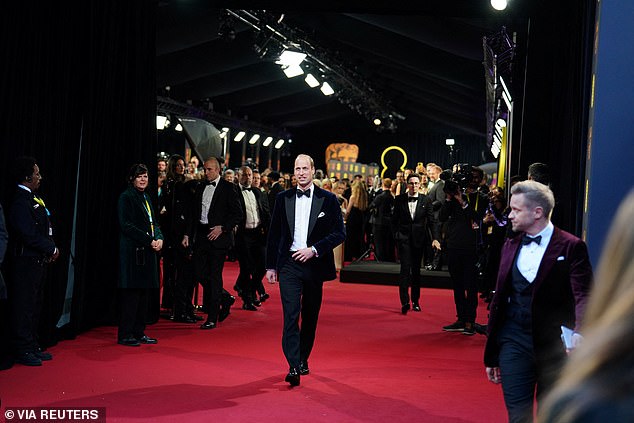 Flanked by tight security, the prince walks into the London landmark;  he has traditionally attended the event with his wife, the Princess of Wales