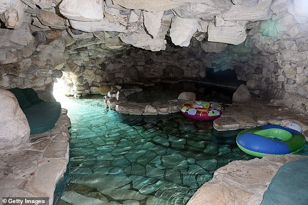 The former Playboy model recalled how Timberlake stripped down to his shorts and jumped into the mansion's infamous cave (pictured)