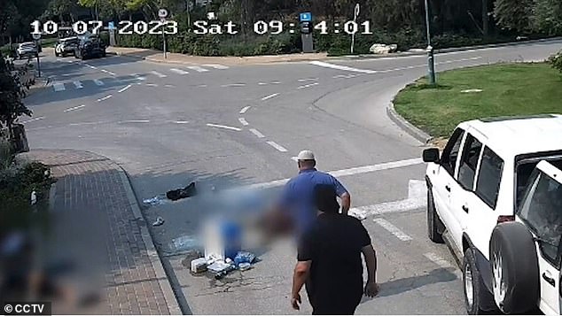 The footage shows the two men approaching an off-duty IDF soldier who is lying motionless on the road