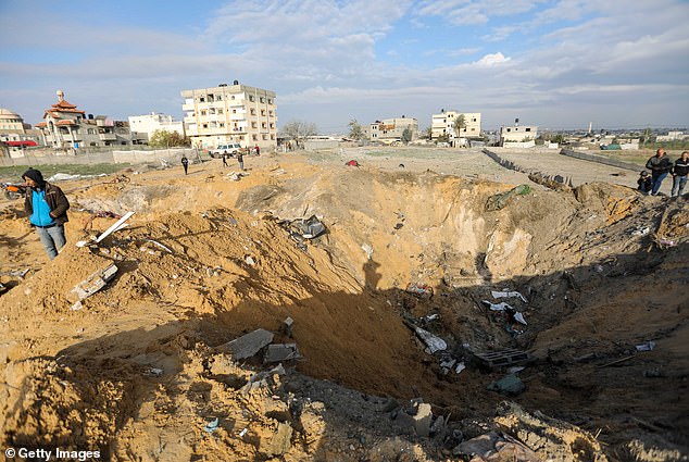 People in Gaza inspect the damage to their homes after an Israeli airstrike on Sunday