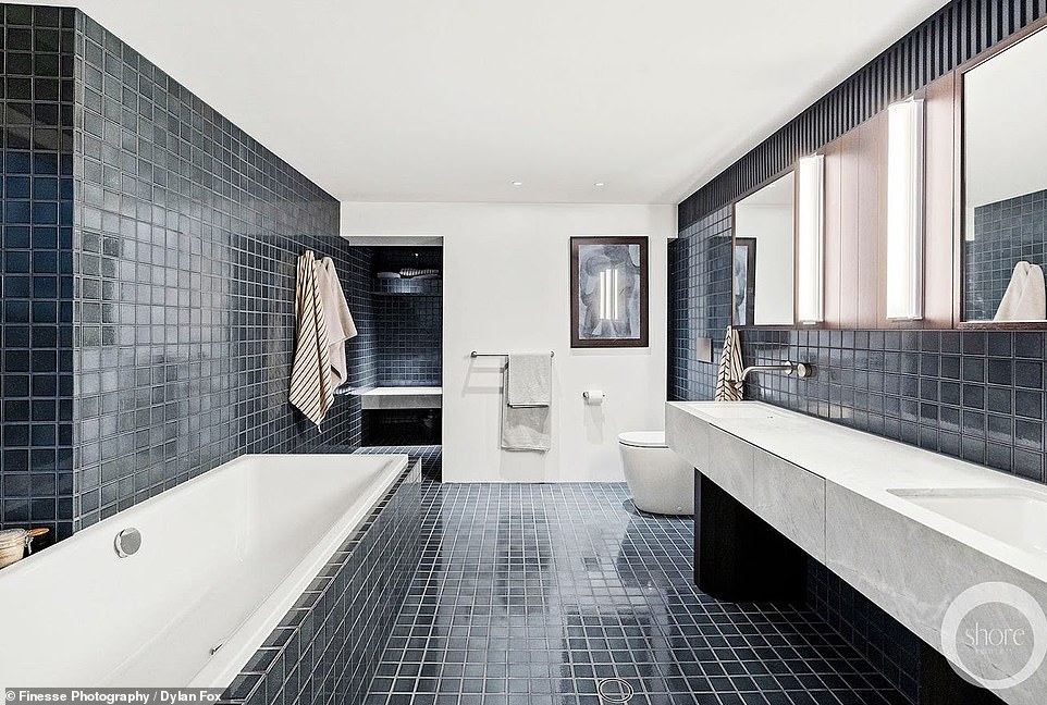 The bathroom is also beautiful with black tiles