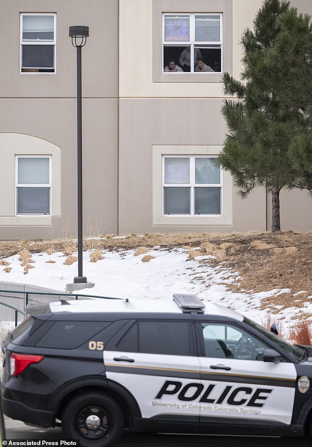 Shocked students look out the window of their dorm at the Village at Alpine Valley residences