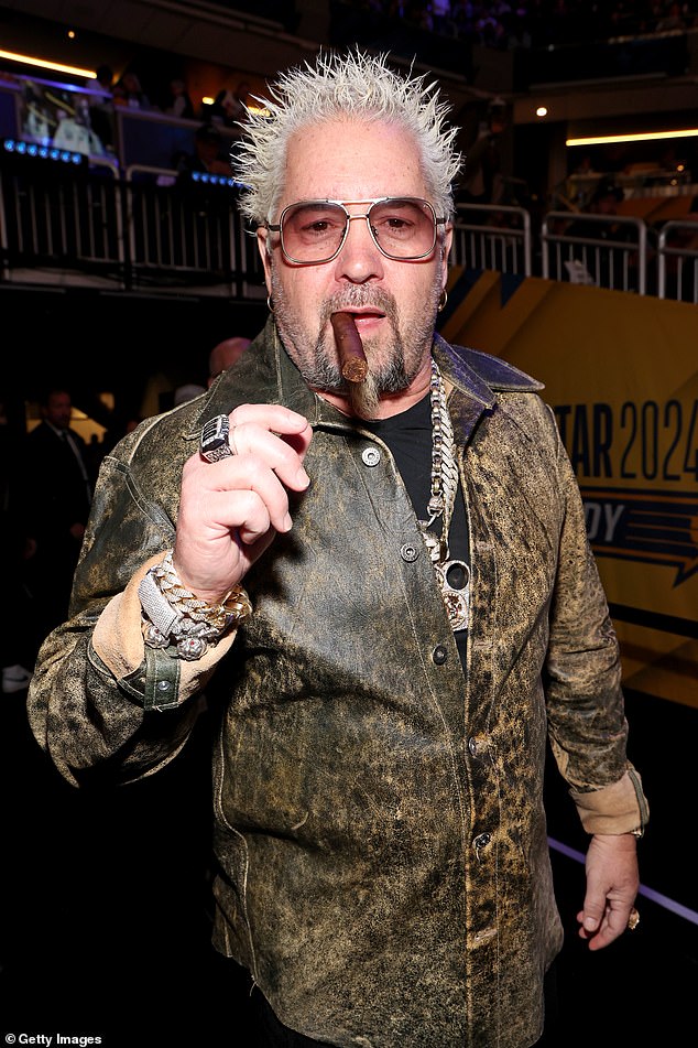 Guy Fieri posed during the match with a cigar in his mouth and some flashy jewelry