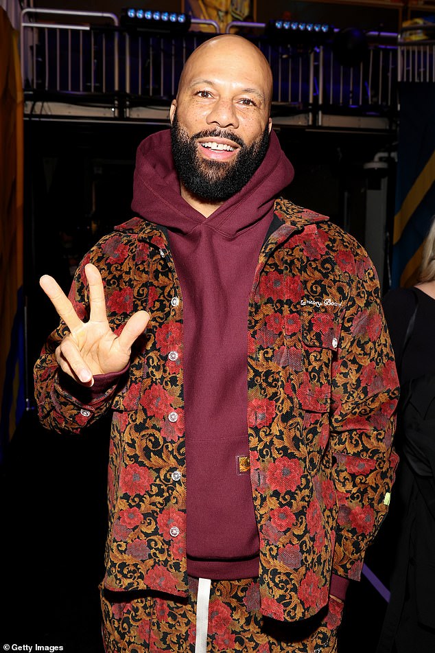 Rapper Common wore a floral jacket and maroon hoodie as he posed for the camera