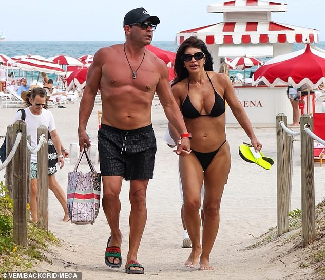 Teresa showed off her curves in a tiny black bikini, consisting of a triangle top and thong bottoms.  The Real Housewives of New Jersey star's long, dark hair was styled in loose waves