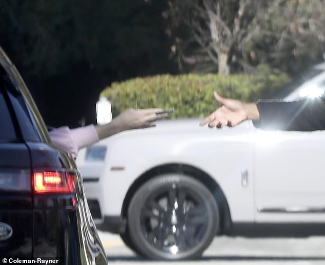 Heather hands the beggar the money as her fiancé Chris Heisser stopped at a traffic light in Thousand Oaks, California