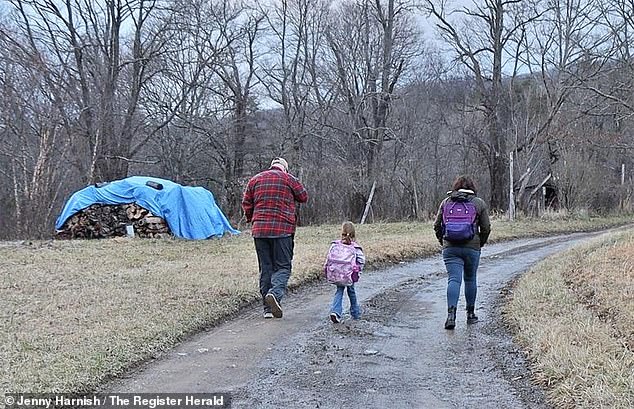 Five-year-old Kolbie Hale and her parents Erin and Rick walk home from the bus stop with their daughter