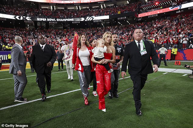 Patrick Jr.'s mother Randi (left) and wife Brittany walk onto the field after Super Bowl LVIII