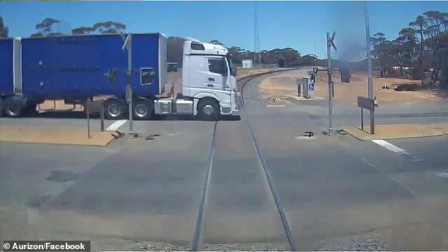 The freight train driver avoided disaster when they hit the brakes after seeing that the road train (pictured) would not stop