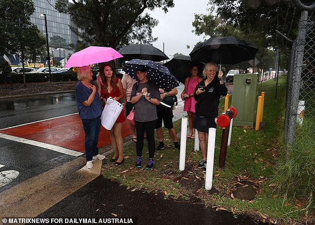 Swift's plane was delayed by half an hour when the pop star arrived in Sydney on Monday (Photo: Eager fans wait to catch a glimpse of her at Sydney Airport)