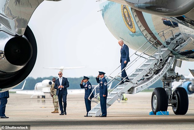 Two Air Force agents and one Secret Service agent wait for Biden at the bottom of the shorter staircase leading to the lower entrance of Air Force One