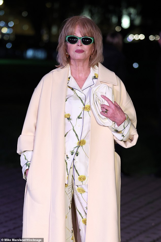 Joanna wore a white shirt and wide-leg trousers for the show, decorated with yellow flowers, and wore huge green oval sunglasses