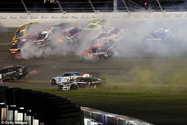 Sparks and smoke fly from the cars after the crash, which had less than ten laps to go