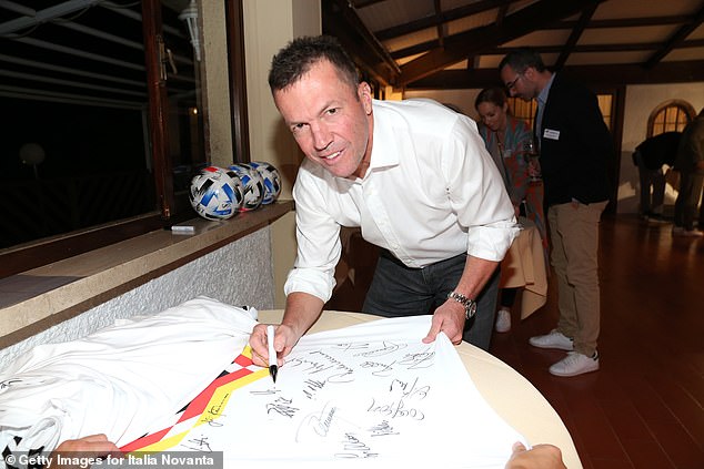 Lothar Matthaus signing a 1990 Germany shirt at a reunion event in Italy in October 2020