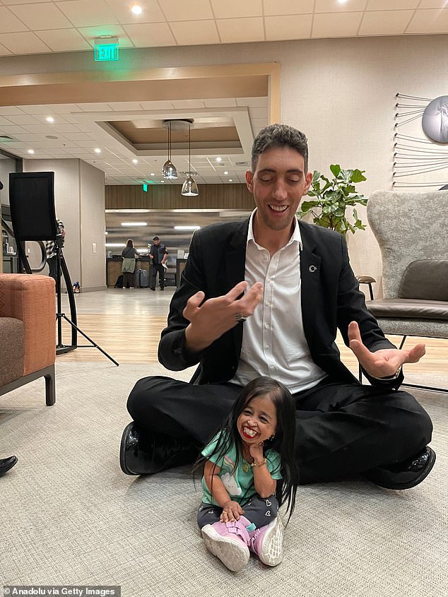 The world's tallest living man Sultan Kosen, who is 251 cm (8 ft 2.82), meets Jyoti Amge, the shortest woman in the world, who is 62.8 centimeters tall in Irvine, California