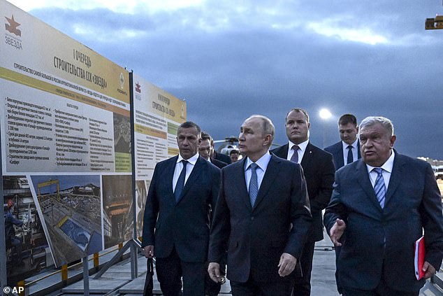 Russian President Vladimir Putin, center, and Russian CEO of Rosneft oil company Igor Sechin, right, visiting 