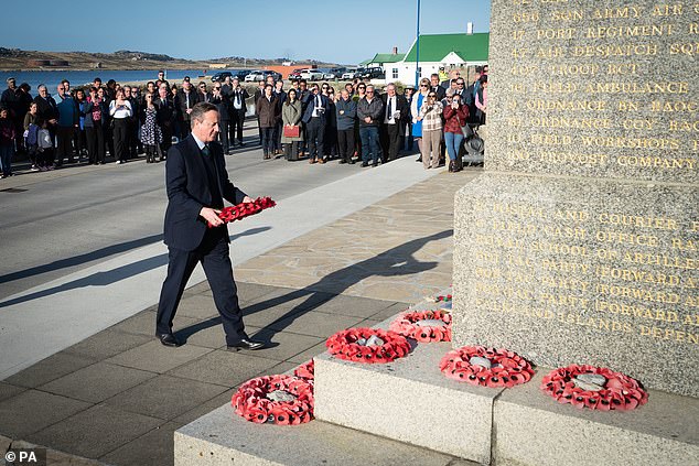 Foreign Secretary Lord David Cameron attends a wreath-laying ceremony at the Falklands Conflict Memorial in Port Stanley in the Falkland Islands