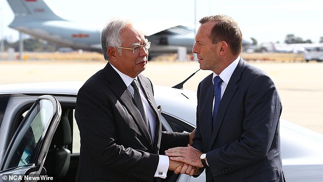 Then Australian Prime Minister Tony Abbott (right) bids farewell to then Malaysian Prime Minister Najib Razak after his visit to Perth during the search for missing Malaysia Airlines Flight MH370 at Perth International Airport on April 3, 2014