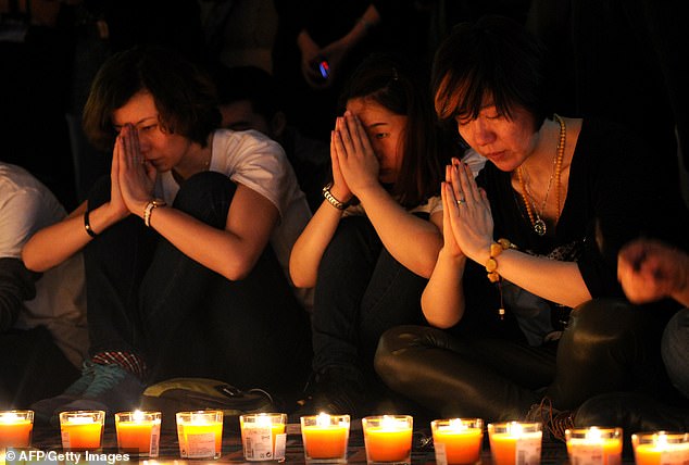 Chinese relatives of passengers on the missing Malaysia Airlines Flight MH370 participate in a prayer service at the Metro Park Hotel in Beijing, China, in 20