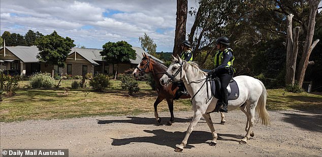 Police on horseback walk past Murphy's home in the days after Samantha Murphy disappeared