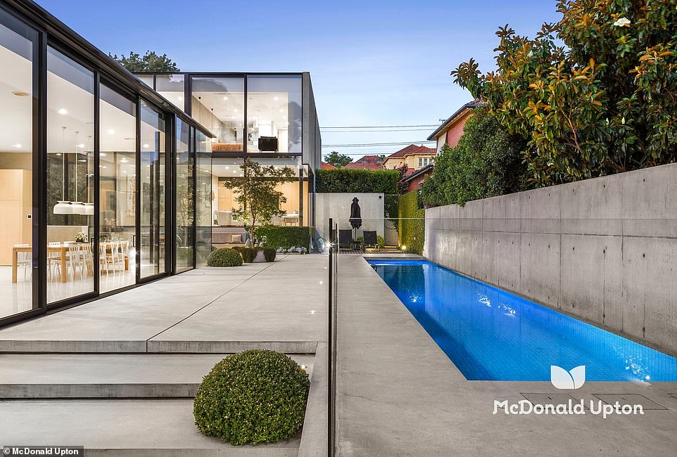 In the kitchen there is a five-metre-long bench, with a butler's pantry hidden at the end of the chic wooden joinery.  Floor-to-ceiling window walls add volume to the family room and blur the lines between indoor living and outdoor luxury